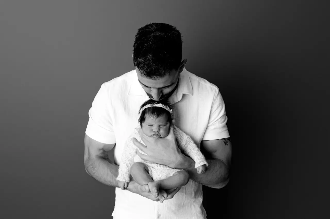 A father holding his newborn daughter